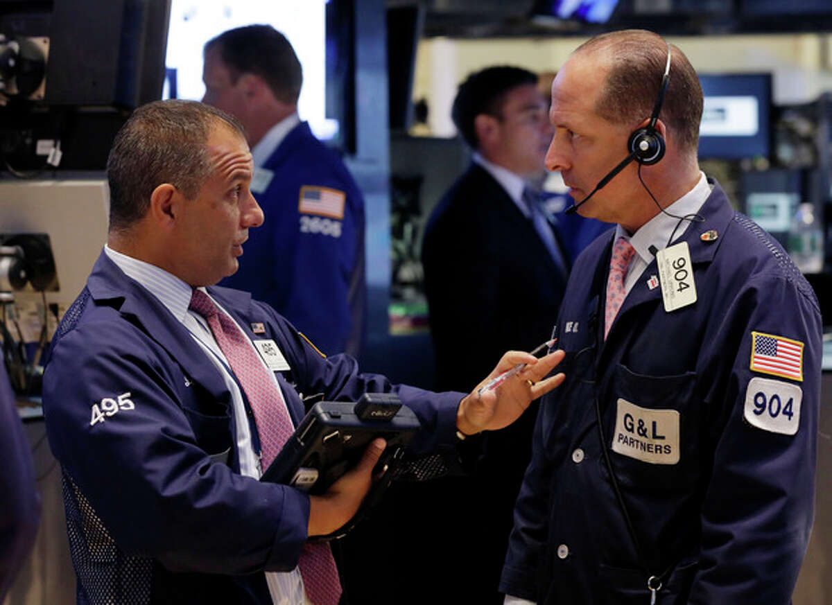 In this Monday, July 8, 2013 photo, traders Joel Lucchese, left, and Michael Urkonis confer on the floor of the New York Stock Exchange. Asian stock markets rebounded and European shares continued a global rally Tuesday July 9, 2013 following positive U.S. economic news as nervousness about an imminent scaling back of the Federal Reserve's monetary stimulus eased. (AP Photo/Richard Drew)