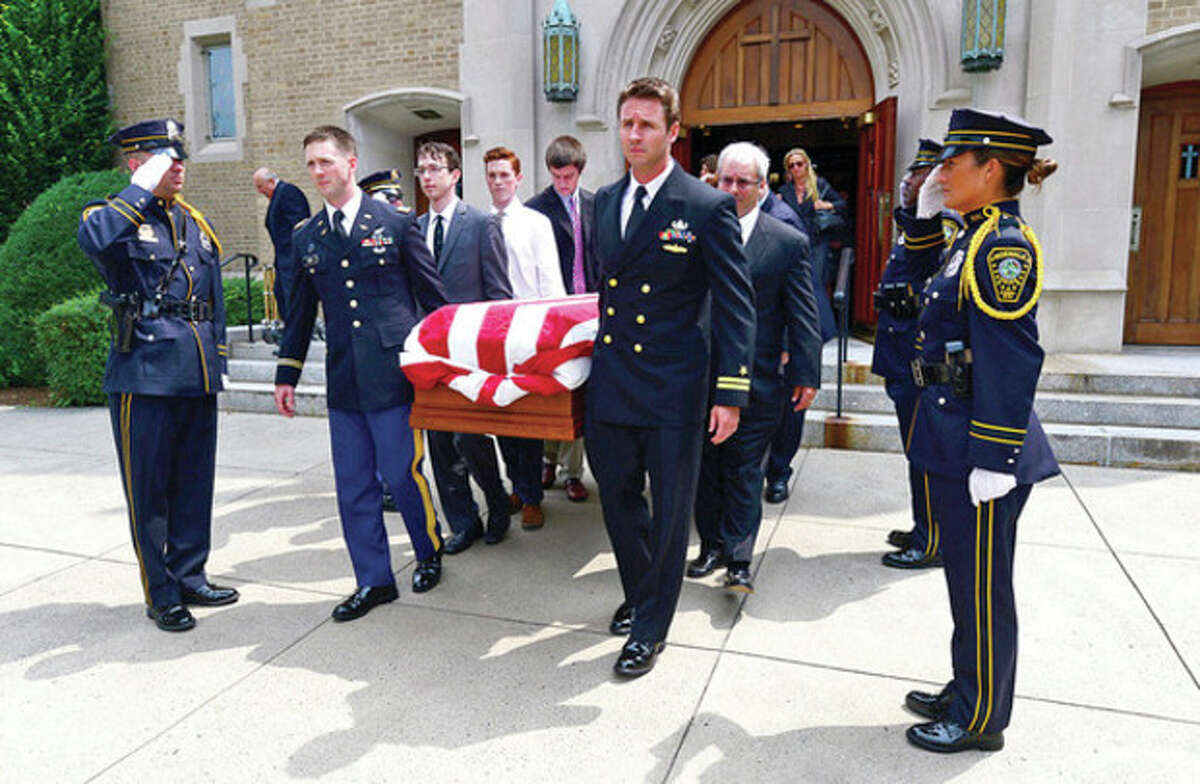 Hour photo / Erik Trautmann Pallbearers bring the casket of former mayor Don Irwin through the Norwalk Police Honor Guard following the service Wednesday at St. Thomas the Apostle Church.