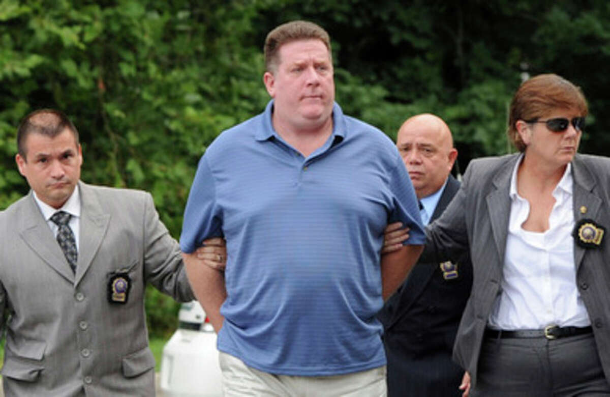 Raymond Roth, center, is escorted by law enforcement officers to the Long Island State Park Police Headquarters, Wednesday, Aug. 15, 2012 in Babylon, N.Y. Roth is suspected of faking his own drowning at a New York beach in a scheme to collect on a life insurance policy. The 47-year-old was reported missing by his son on July 28 at Jones Beach. (AP Photo/Kathy Kmonicek)