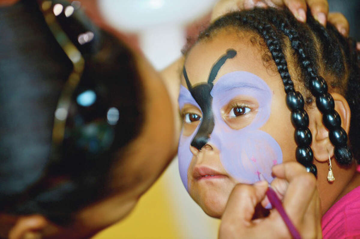 Tamariah Peterson, 4, gets her face painted during Roodner Court Family Day Saturday at Nathaniel Ely School. Hour photo / Erik Trautmann