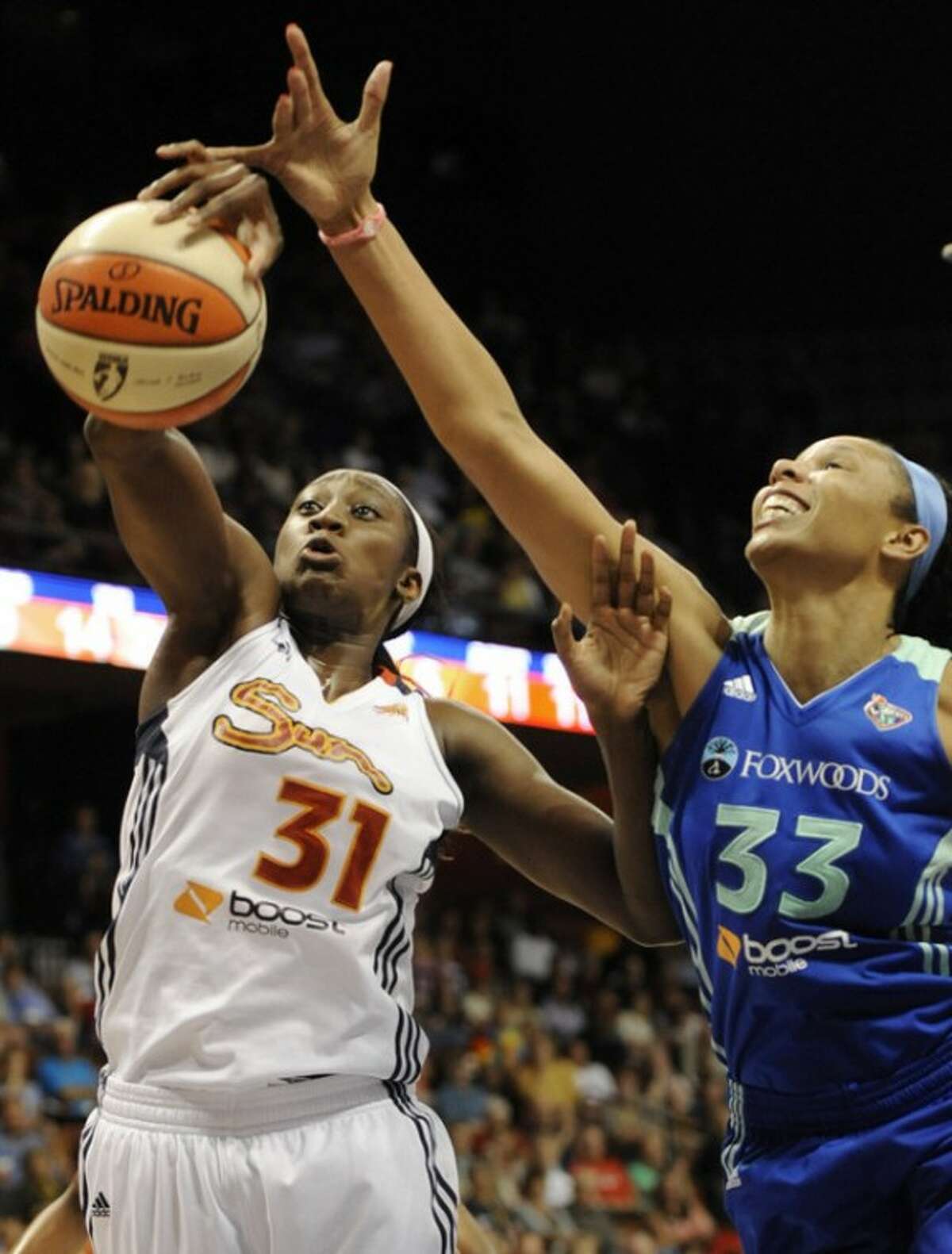 Connecticut Sun's Tina Charles (31) grabs a defensive rebound against New York Liberty's Plenette Pierson (33) during the first half of a WNBA basketball game in Uncasville, Conn., Saturday, Aug. 18, 2012. (AP Photo/Jessica Hill)