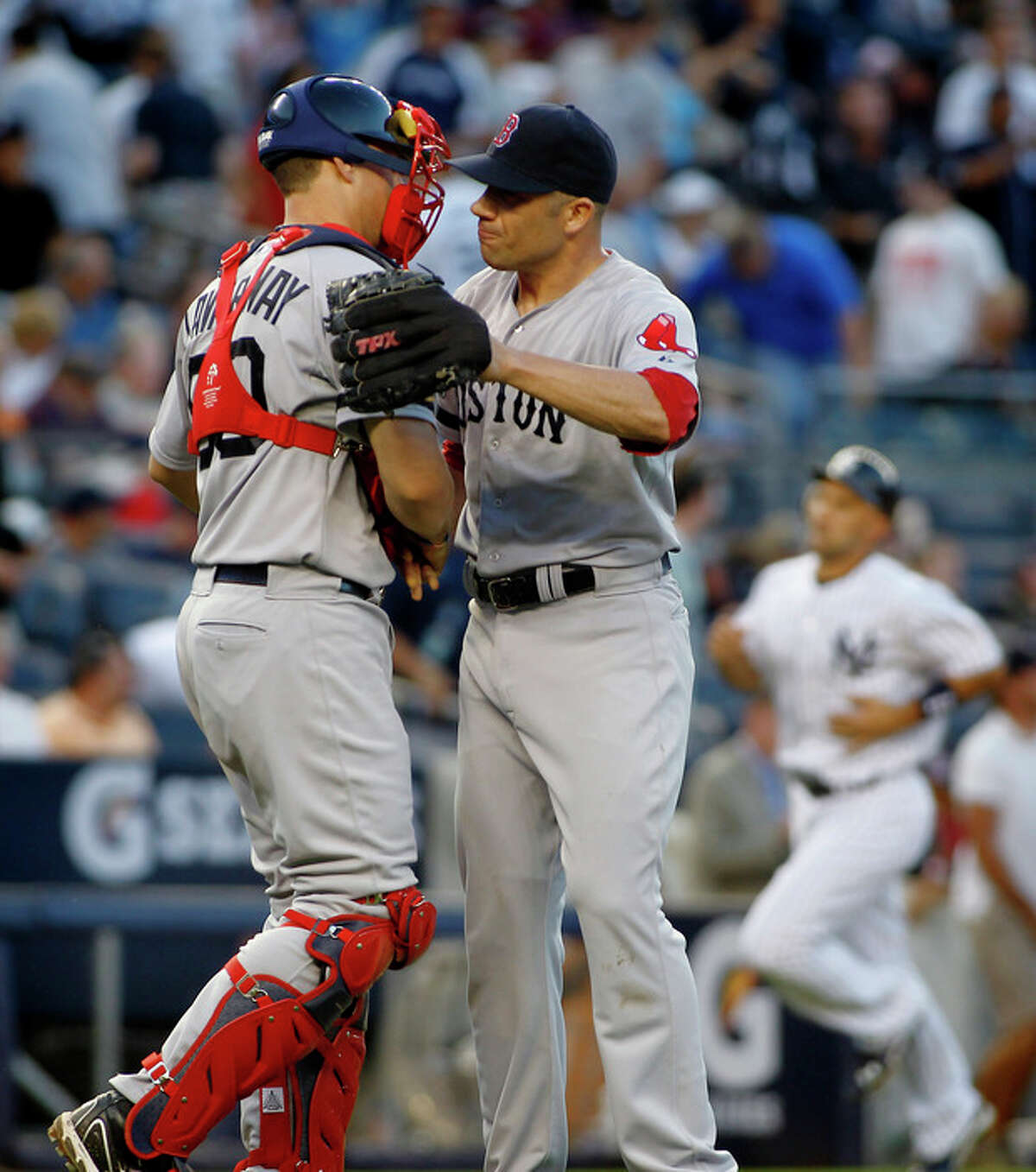 Boston Red Sox's Ryan Lavarnway (60) congratulates pitcher Alfredo Aceves, right, after he closed out the New York Yankees in the ninth inning of a baseball game, Saturday, Aug. 18, 2012, at Yankee Stadium in New York. The Red Sox defeated the Yankees 4-1. (AP Photo/John Dunn)