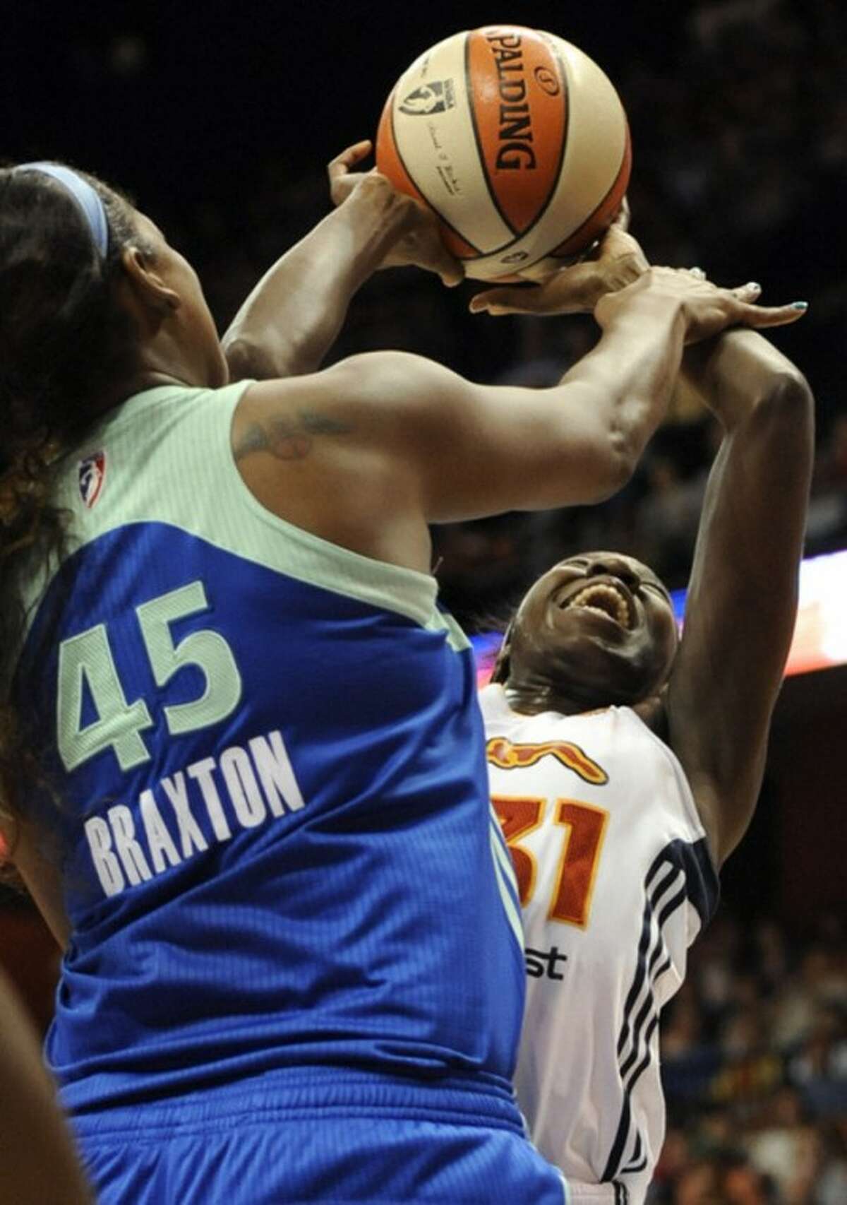 Connecticut Sun's Tina Charles, right, is fouled by New York Liberty's Kara Braxton (45) during the first half of a WNBA basketball game in Uncasville, Conn., Saturday, Aug. 18, 2012. (AP Photo/Jessica Hill)