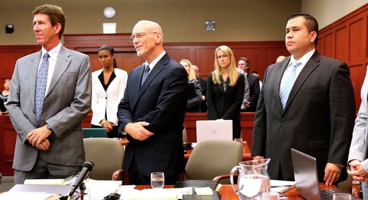 George Zimmerman, right, stands with his attorneys, Mark O'Mara, left, and Don West, center, as the jury enters the courtroom during the 16th day of his trial in Seminole circuit court, in Sanford, Fla., Monday, July 1, 2013. Zimmerman has been charged with second-degree murder for the 2012 shooting death of Trayvon Martin.(AP Photo/Orlando Sentinel, Joe Burbank, Pool)