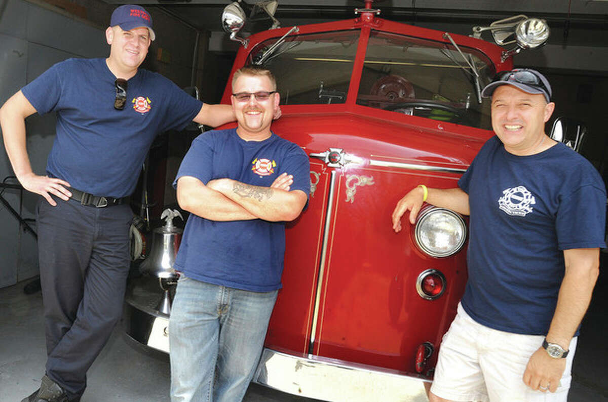 Hour photo / Matthew Vinci Firefighters from the Saugatuck Fire Station will particiapte in a cookoff at the Fairway in Stamford on July 13th. From left, James Workman, Joe Arnson and Brett Kirby.
