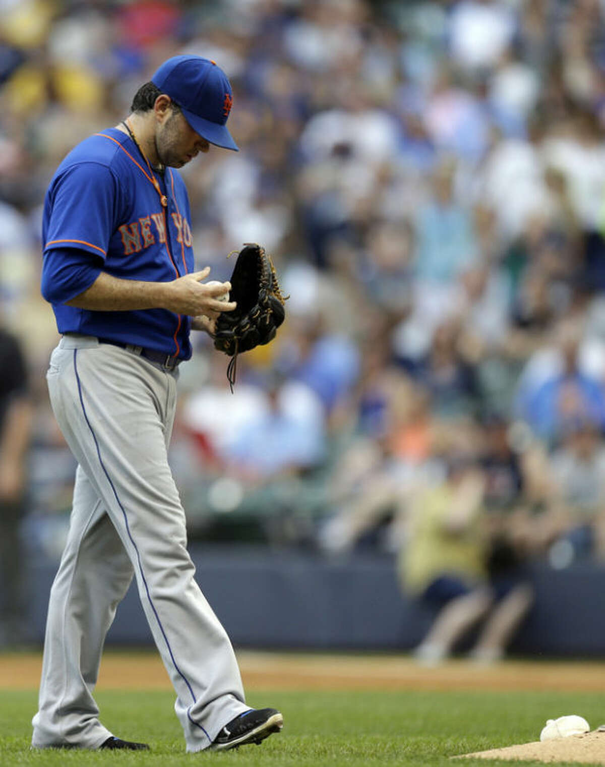 New York Mets starting pitcher Shaun Marcum walks back to the mound during the third inning of a baseball game against the Milwaukee Brewers, Saturday, July 6, 2013, in Milwaukee. (AP Photo/Jeffrey Phelps)
