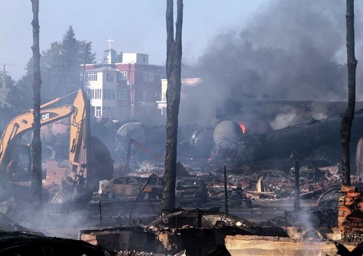 In a Monday, July 8, 2013 photo provided by Surete du Quebec via The Canadian Press, the downtown core lies in ruins in Lac-Megantic, Quebec, in a Surete du Quebec. Thirteen people are confirmed dead and forty more are listed as missing after a train derailed ignited tanker cars carrying crude oil. (AP Photo/Surete du Quebec via The Canadian Press)