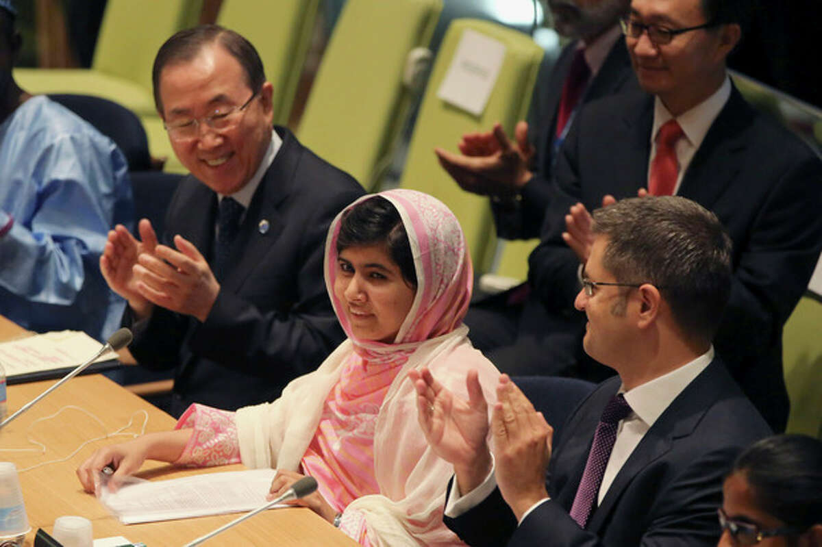 United Nations Secretary-General Ban Ki-moon, left, applauds as the members of the ?‘Malala Day?’ Youth Assembly wish Malala Yousafzai, center, a happy birthday, Friday, July 12, 2013 at United Nations headquarters. Yousafzai, the Pakistani teenager shot by the Taliban for promoting education for girls, celebrated her 16th birthday on Friday by addressing the United Nations. The U.N. has declared July 12 "Malala Day," to honor the teen who returned to school in March after medical treatment in Britain for injuries suffered in the October attack. (AP Photo/Mary Altaffer)