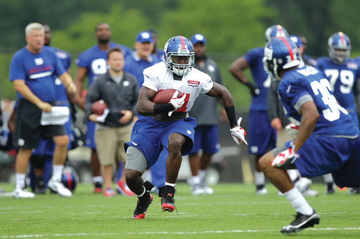 AP photo New York Giants running back and 2012 first round draft pick David Wilson, left, runs with the ball as cornerback Jayron Hosley defends during a training camp session in Albany, N.Y. Wilson is expected get see action Friday night against the Chicago Bears.