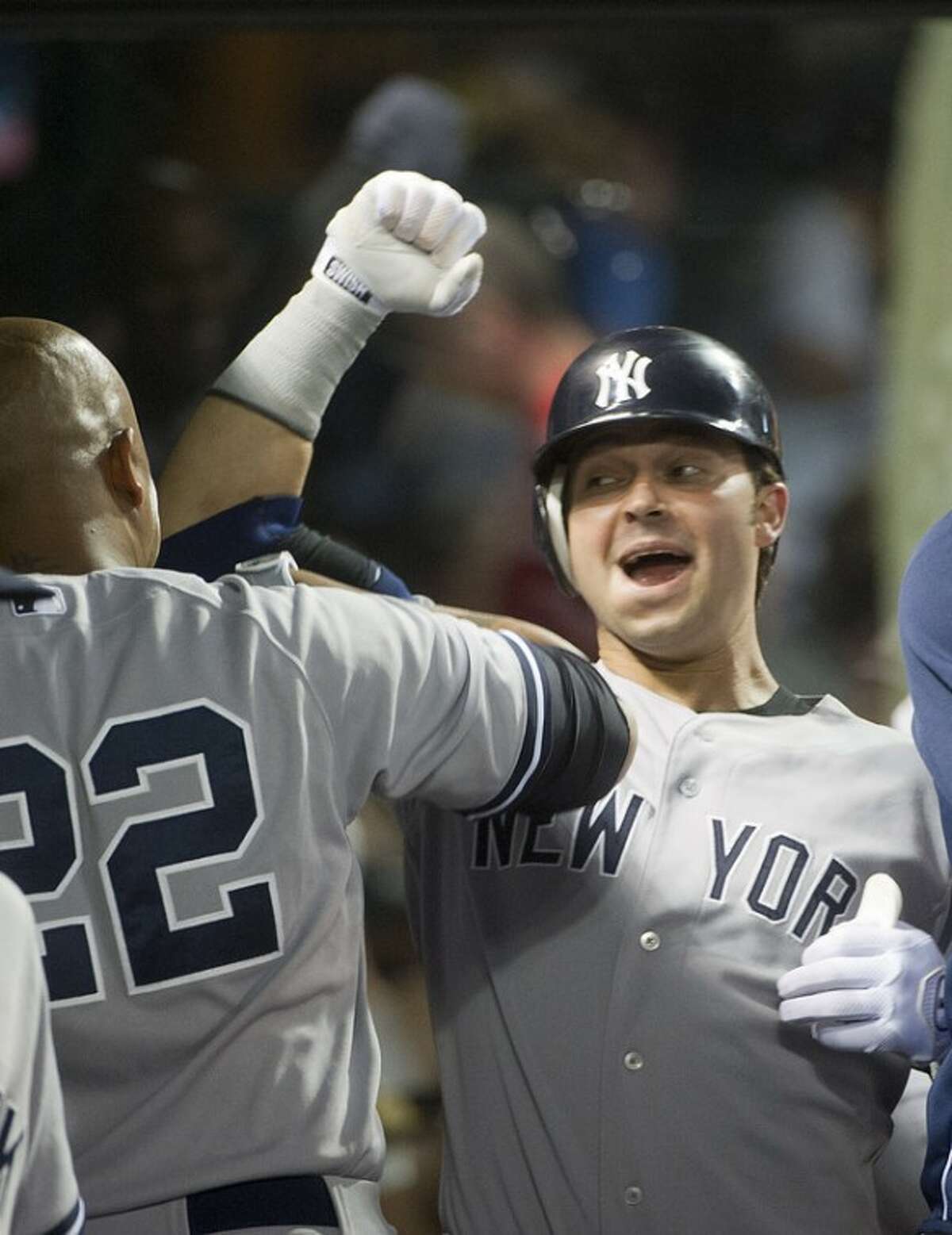 Nick Swisher of the New York Yankees, celebrates his seventh inning two-run home run off Cleveland Indians reliever Tony Sipp, with Andruw Jones (22) during a baseball game in Cleveland, Friday, Aug. 24, 2012. (AP Phil Long)