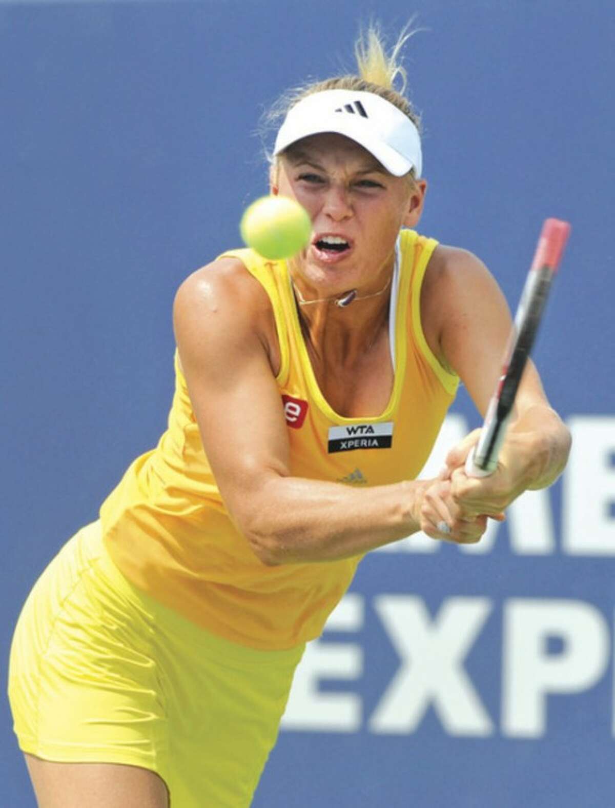 AP photo Caroline Wozniacki hits a backhand during her semifinal match against Maria Kirilenko Friday at the New Haven Open. The four-time defending champ, Wozniacki retired due to a knee injury after dropping the first set to Maria Kirilenko.