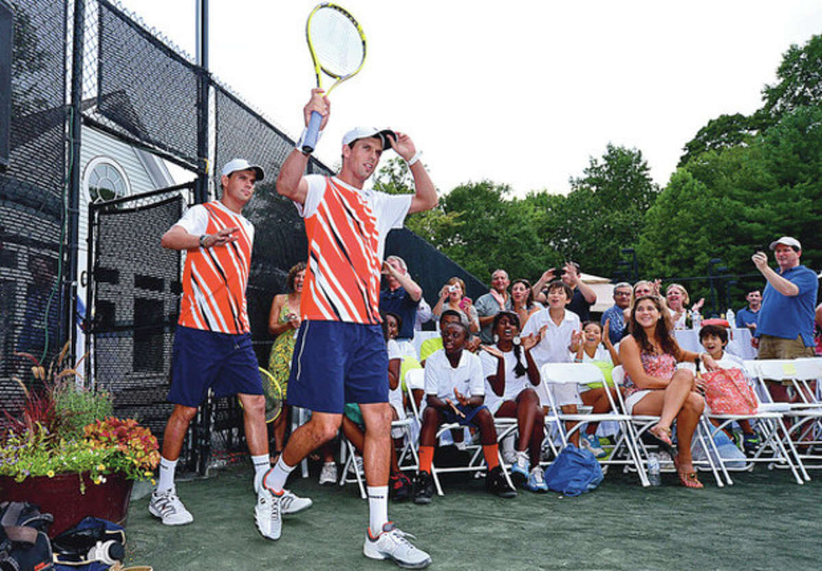 Hour photo/Erik Trautmann Olympic gold medalists and three-time U.S. Open champions Bob and Mike Bryan walk toward the court at the Lake Club in Wilton Saturday for a professional tennis exhibition. Some of the proceeds from the benefit program went to Norwalk Grassroots Tennis.