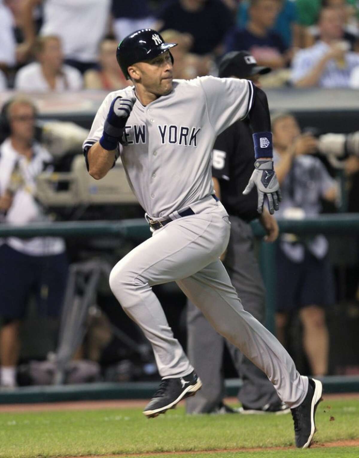 New York Yankees' Derek Jeter heads home to score on a sacrifice fly by Mark Teixeira in the sixth inning of a baseball game against the Cleveland Indians, Saturday, Aug. 25, 2012, in Cleveland. (AP Photo/Tony Dejak)