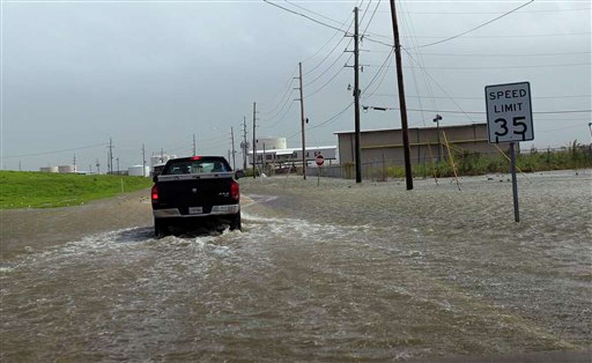 A Plaquemines Parish vehicle rides through rising floodwater behind the levee as Isaac approaches, which is expected to make landfall in the region as a hurricane this evening in Venice, La., the southernmost tip of Louisiana, Tuesday, Aug. 28, 2012. Venice has been under a mandatory evacuation. Forecasters at the National Hurricane Center warned that Isaac, especially if it strikes at high tide, could cause storm surges of up to 12 feet (3.6 meters) along the coasts of southeast Louisiana and Mississippi and up to 6 feet (1.8 meters) as far away as the Florida Panhandle. (AP Photo/Gerald Herbert)