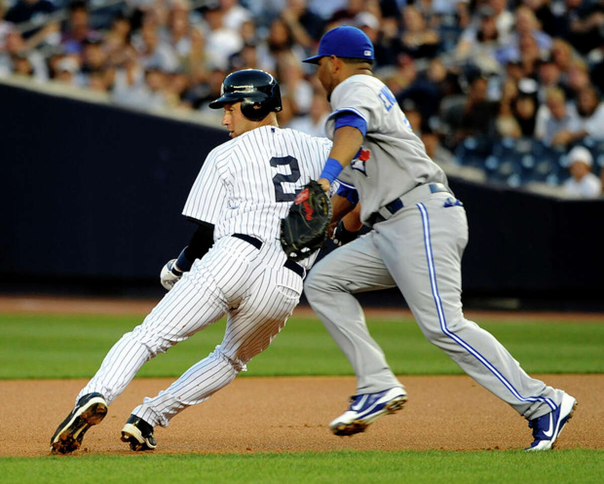 New York Yankees' Derek Jeter (2) is tagged out by Toronto Blue Jays first baseman Edwin Encarnacion in the first inning of a baseball game on Tuesday, Aug., 28, 2012, in New York. (AP Photo/Kathy Kmonicek)