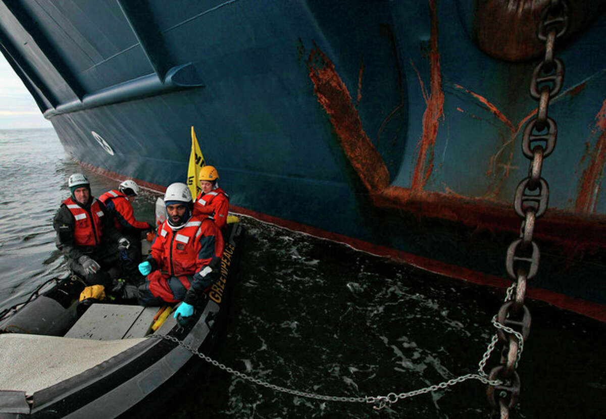 This image made available by environmental organization Greenpeace shows Greenpeace activists chained to the anchor chain of the Anna Akhmatova, the vessel which was carrying Gazprom's workers to the Prirazlomnaya platform, in the Pechora Sea about 620 miles (1,000 kilometers) from the nearest port, Murmansk, a city on the extreme northwestern edge of the Russian mainland, Monday Aug. 27, 2012. Gazprom is pioneering Russia's oil drilling in the Arctic. The state-owned company installed the platform there last year and is preparing to drill the first well. Environmentalists have warned that drilling in the Russian Arctic could have disastrous consequences because of a lack of technology to deal with a possible spill in this remote region. (AP Photo/Denis Sinyakov/Greenpeace, HO)