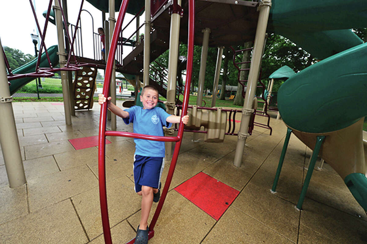 12 tearold Branden McDermott plays on the new playground on Thursday when the renovated Scalzi Park was officially reopened. Hour photo / Erik Trautmann