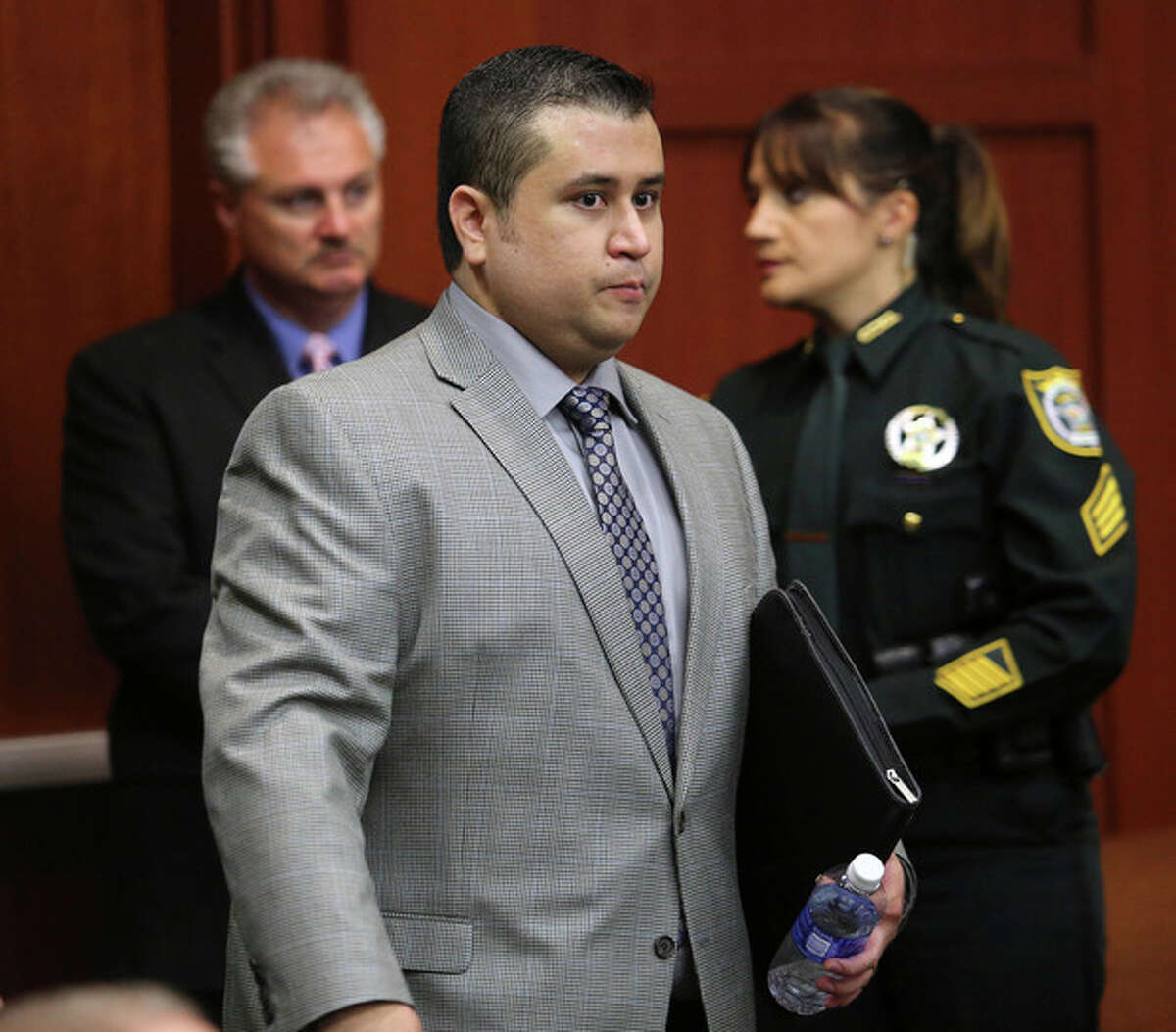 George Zimmerman arrives for the 17th day of his trial in Seminole circuit court, Tuesday, July 2, 2013 in Sanford, Fla. Zimmerman is charged with 2nd-degree murder in the fatal shooting of Trayvon Martin, an unarmed teen, in 2012. (AP Photo/Orlando Sentinel, Joe Burbank, Pool)
