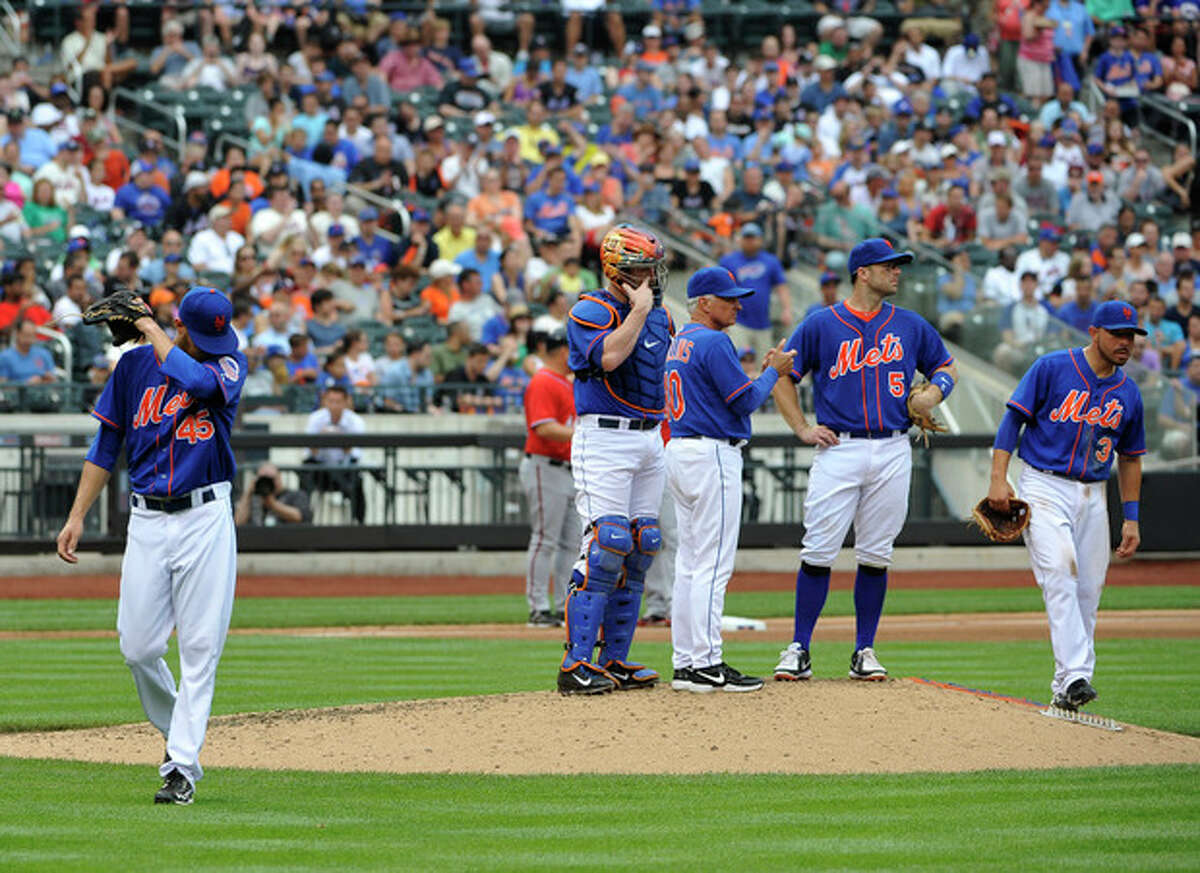 New York Mets starting pitcher Zack Wheeler (45) walks to the dugout after being taken out of the baseball game against the Washington Nationals' in the fifth inning by manager Terry Collins (10) at Citi Field on Sunday, June 30, 2013 in New York. (AP Photo/Kathy Kmonicek)