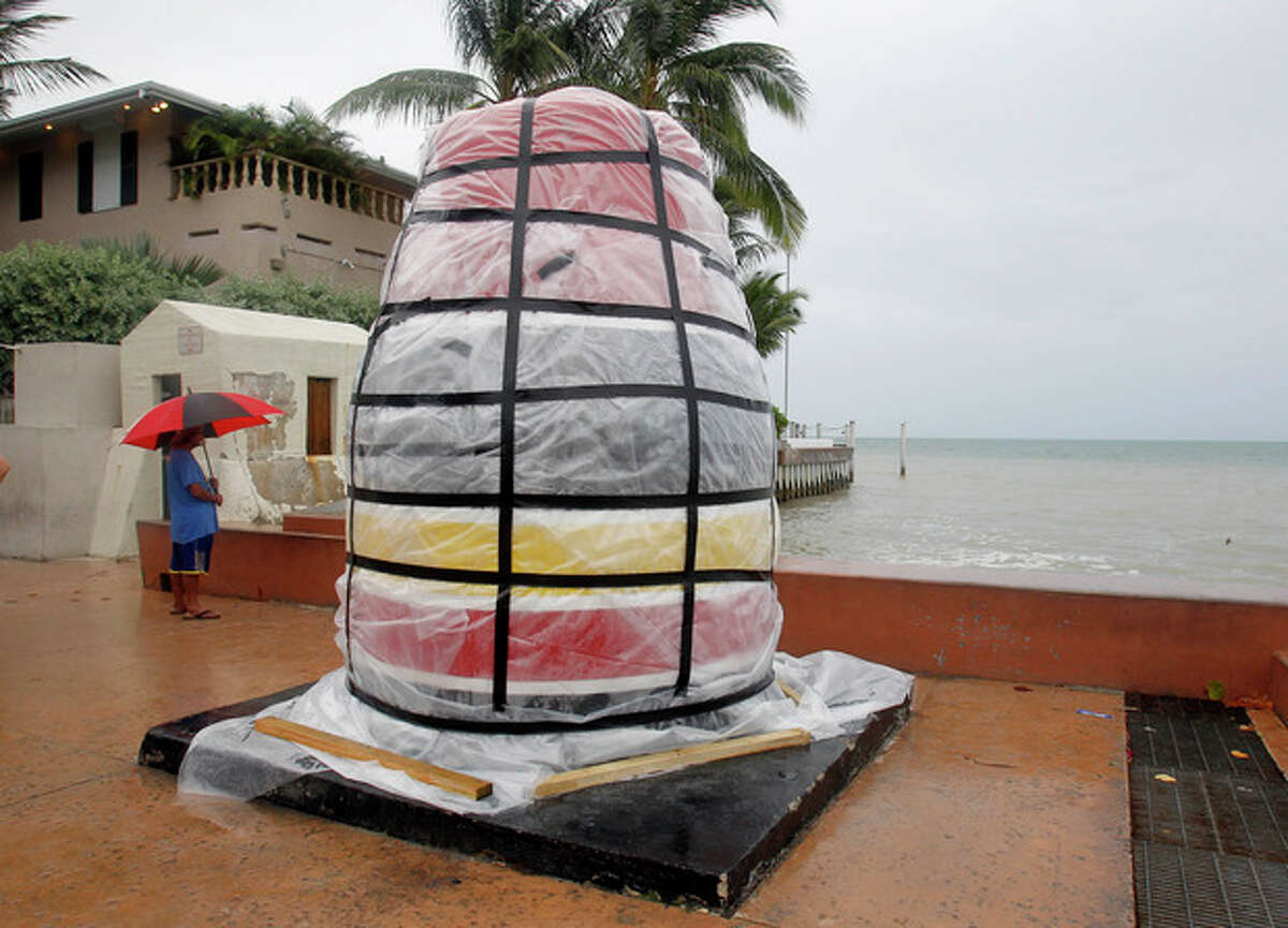 The southernmost point marker is covered in plastic sheeting in Key West, Fla., Saturday, Aug. 25, 2012, in preparation for Tropical Storm Isaac, Saturday, Aug. 25, 2012. Isaac's winds are expected to be felt in the Florida Keys by sunrise Sunday morning. (AP Photo/Alan Diaz)