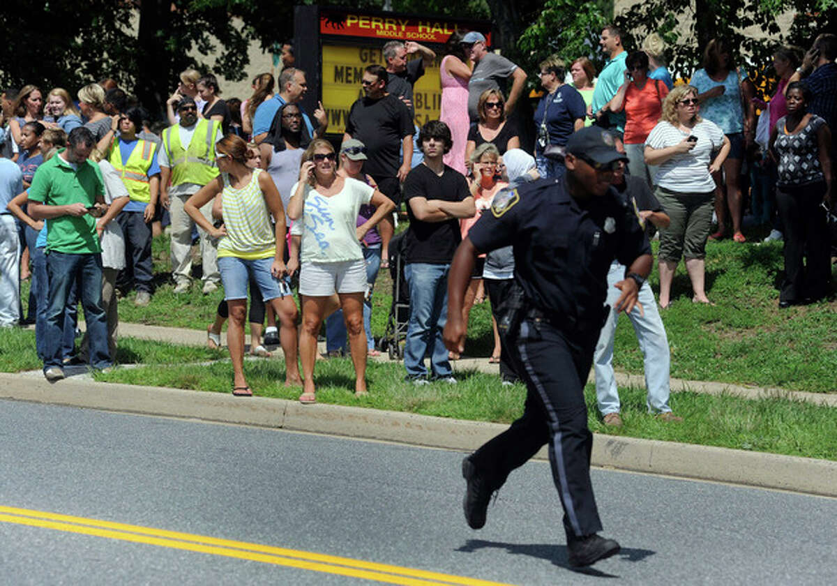 Parents wait to reunite with their children after a student was shot and critically wounded on the first day of classes at Perry Hall High School, Monday, Aug. 27, 2012, in Perry Hall, Md. A suspect was taken into custody shortly after the shooting, according to police. No one else was reported injured. (AP Photo/Steve Ruark)