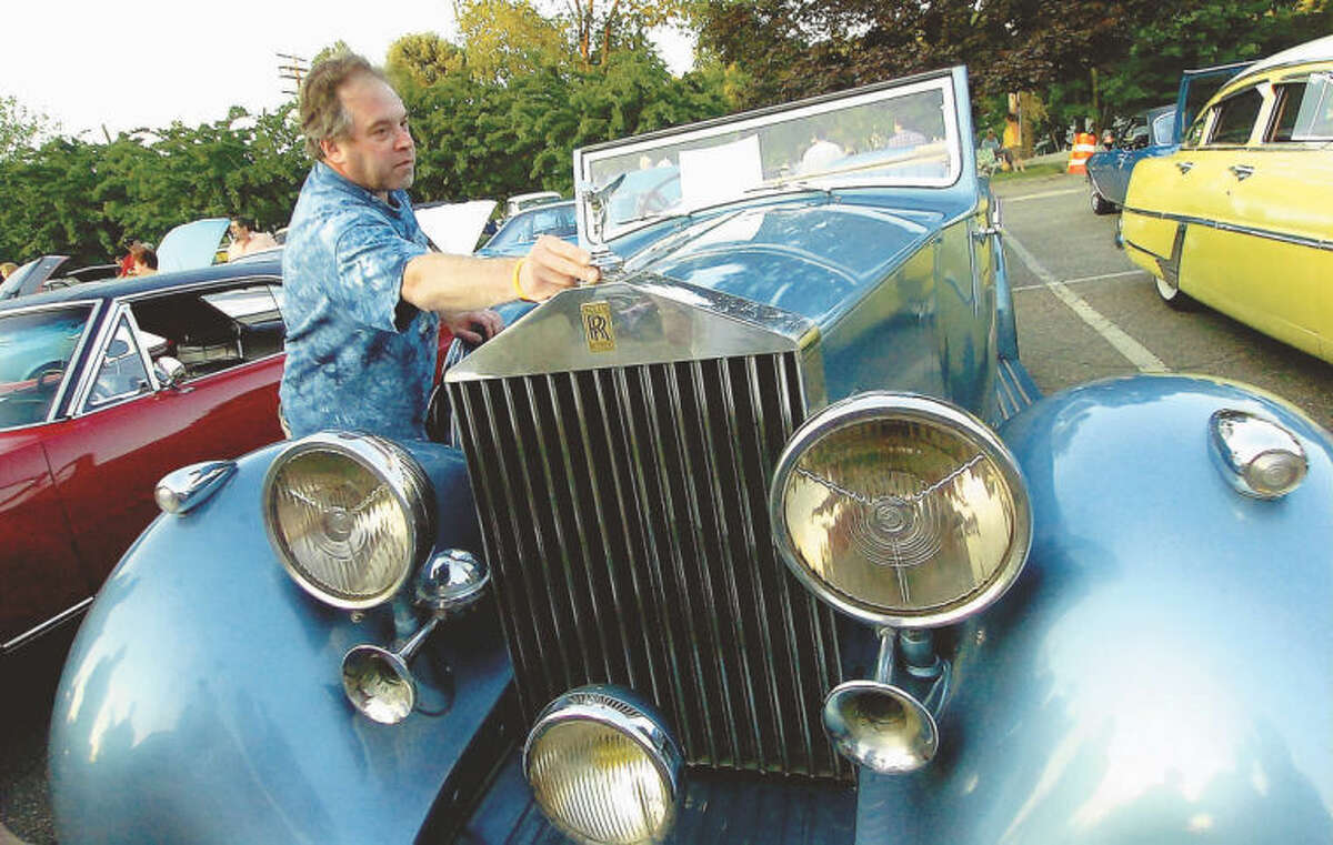Wilton’s Bill Merritt straightens the flying lady on his unrestored 1937 Rolls Royce 25/30 Windover Drophead Convertible during the Kiwanis car show in Wilton Center in this file photo. Automobile collectors and enthusiasts are expected to park more than 100 vintage vehicles in Wilton Center on Friday, July 12 for the 13th annual Kiwanis Club Car Show. The free event, from 6-9 p.m. in the Piersall Building’s parking lot at 44 Old Ridgefield Road, will feature hot rods, motorcycles, and custom, sport and classic cars, all pre-dating 1980.