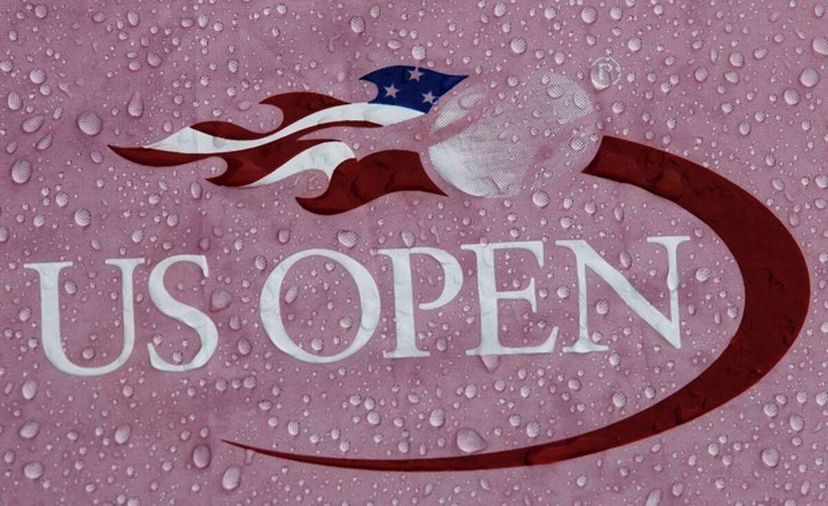 Rain drops cover a logo during a rain delay for the 2012 US Open Tennis tournament, Monday, Aug. 27, 2012, in New York. (AP Photo/Kathy Willens)