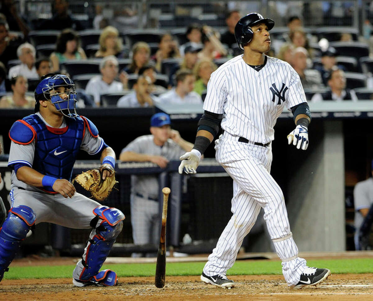 Toronto Blue Jays catcher Yorvit Torrealba watches New York Yankees' Robinson Cano hit his second solo home run in the fourth inning of a baseball game, Monday, Aug. 27, 2012, at Yankee Stadium in New York. (AP Photo/Kathy Kmonicek)