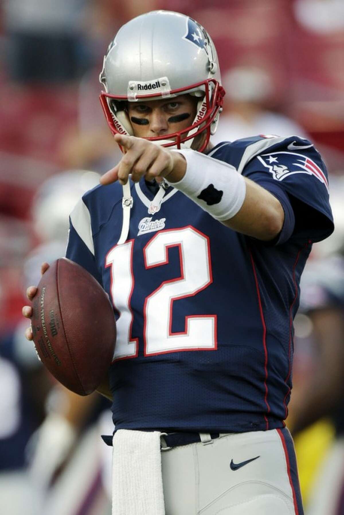 FILE - In this Aug. 24, 2012, file photo, New England Patriots quarterback Tom Brady warms up prior to an NFL preseason football game against the Tampa Bay Buccaneers in Tampa, Fla. The Patriots followed up a season that saw them lose just three regular-season games and nearly win the Super Bowl by adding a deep receiving threat and solidifying their defense to stack up against a soft schedule. The Patriots are scheduled to begin their regular season on Sept. 9 at the Tennessee Titans. (AP Photo/Dave Martin, File)
