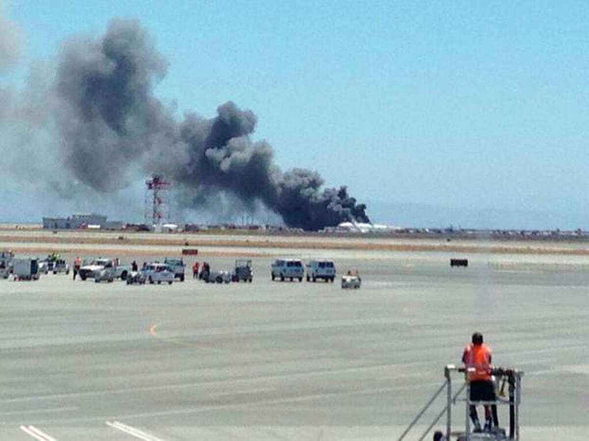 This photo provided by Krista Seiden shows smoke rising from what a federal aviation official says was an Asiana Airlines flight crashing while landing at San Francisco airport on Saturday, July 6, 2013. (AP Photo/Krista Seiden)