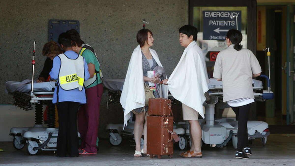 Passengers from Asiana Flight 214 are treated at San Francisco General Hospital after the plane crashed at San Francisco International Airport in San Francisco, Saturday, July 6, 2013. (AP Photo/Bay Area News Group, John Green)