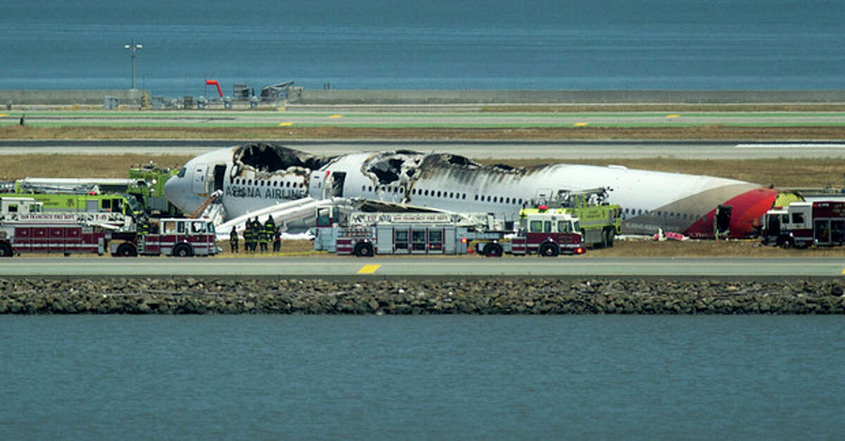 Fire crews respond to the scene where Asiana Flight 214 crashed at San Francisco International Airport on Saturday, July 6, 2013, in San Francisco. (AP Photo/Noah Berger)