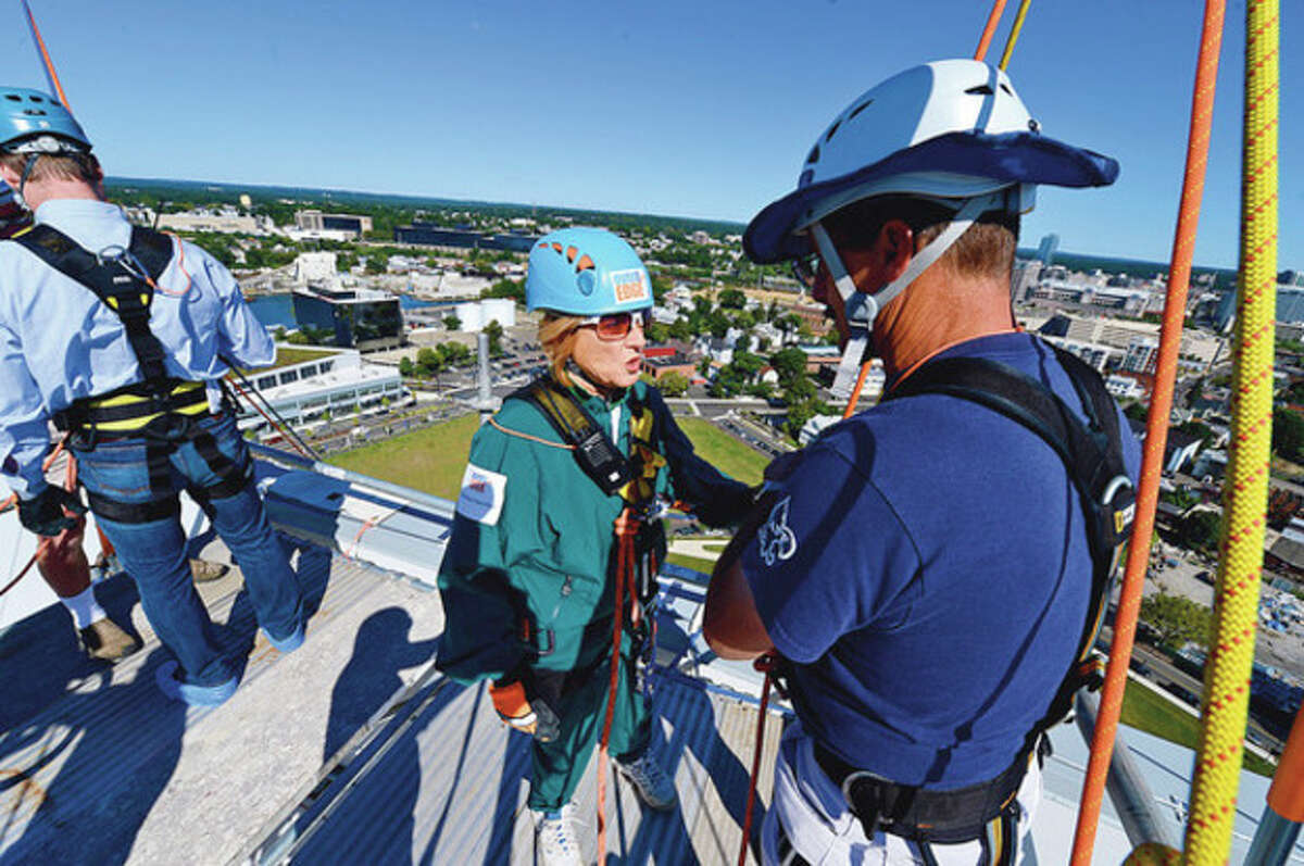 Stamford Superintendent of Schools, Winifred Hamilton, prepares to join the Over the Edge event and rappel down one of Stamford's tallest buildings, the new Infinity building at Harbor Point, to support Special Olympics athletes. Hour photo / Erik Trautmann