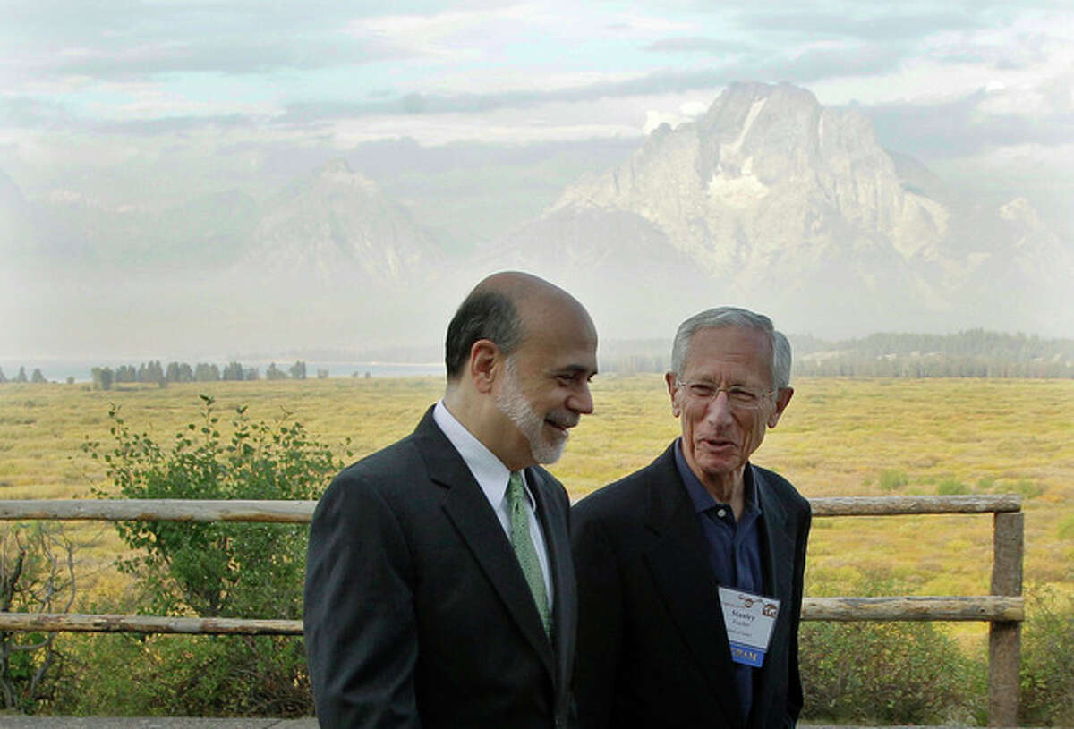 With the Teton Mountains behind them, Federal Reserve Chairman Ben Bernanke, left, and Bank of Israel Governor Stanley Fischer walk together outside of the Jackson Hole Economic Symposium, Friday, Aug. 31, 2012, at Grand Teton National Park near Jackson Hole, Wyo. Bernanke made clear Friday that the Federal Reserve will do more to boost the economy because of high U.S. unemployment and an economic recovery that remains "far from satisfactory." (AP Photo/Ted S. Warren)