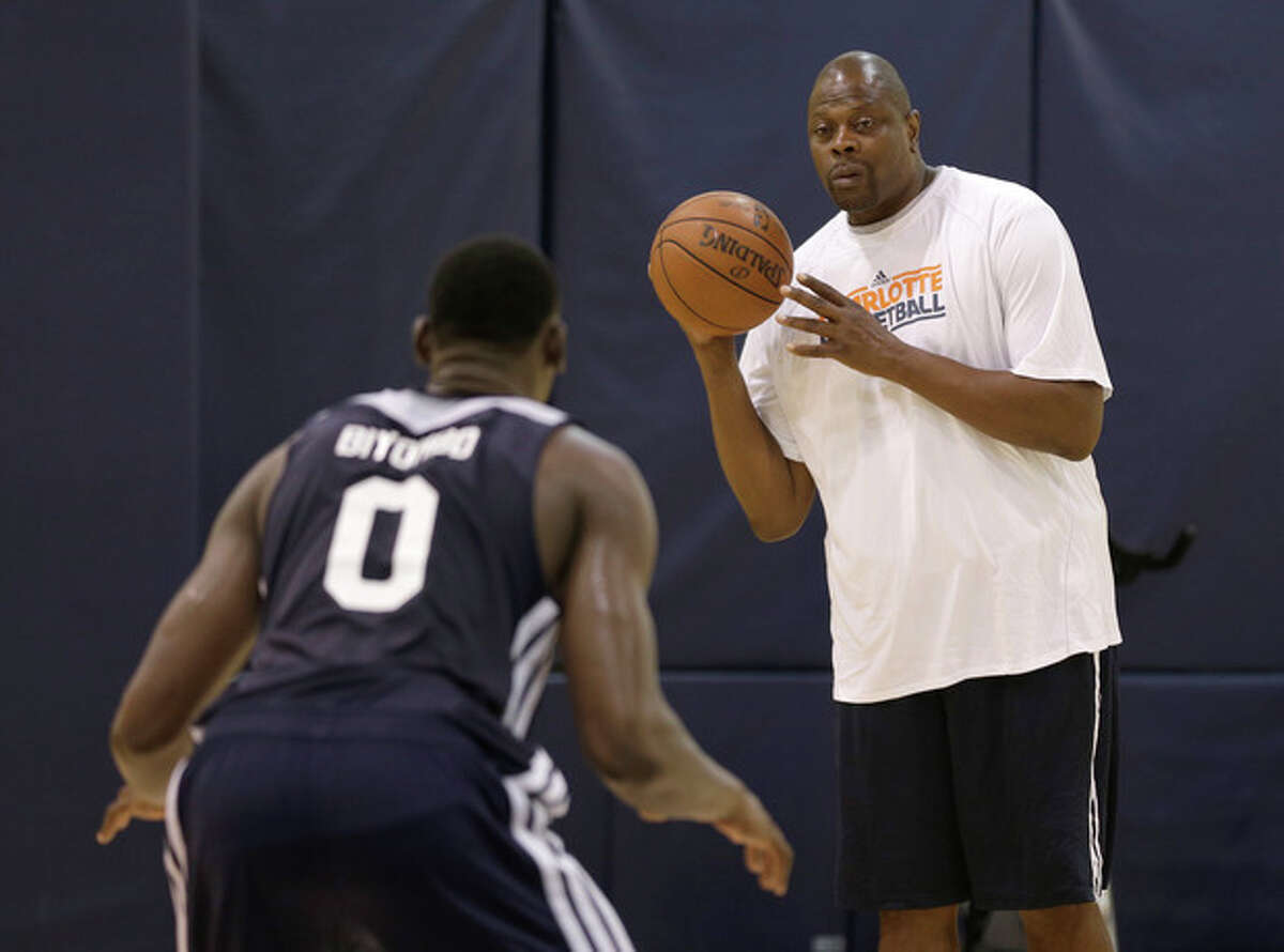 Charlotte Bobcats assistant coach Patrick Ewing, right, works out Bismack Biyombo, left, during the NBA team's summer league basketball practice in Charlotte, N.C., Monday, July 8, 2013. Biyombo, the No. 7 overall pick in the 2011 NBA draft, will have to compete for playing time now that the Bobcats are stocking up on big men. (AP Photo/Chuck Burton)