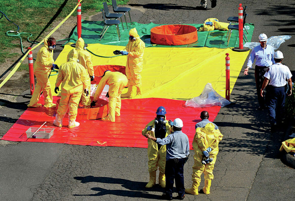 Emergency personnel work to contain a leak at King Industries in Norwalk Thursday morning. Hour photo / Erik Trautmann