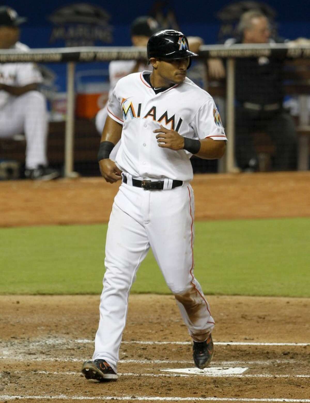 Miami Marlins' Donovan Solano scores on a double by Bryan Petersen in the third inning of a baseball game against the New York Mets in Miami, Saturday, Sept. 1, 2012. (AP Photo/Alan Diaz)