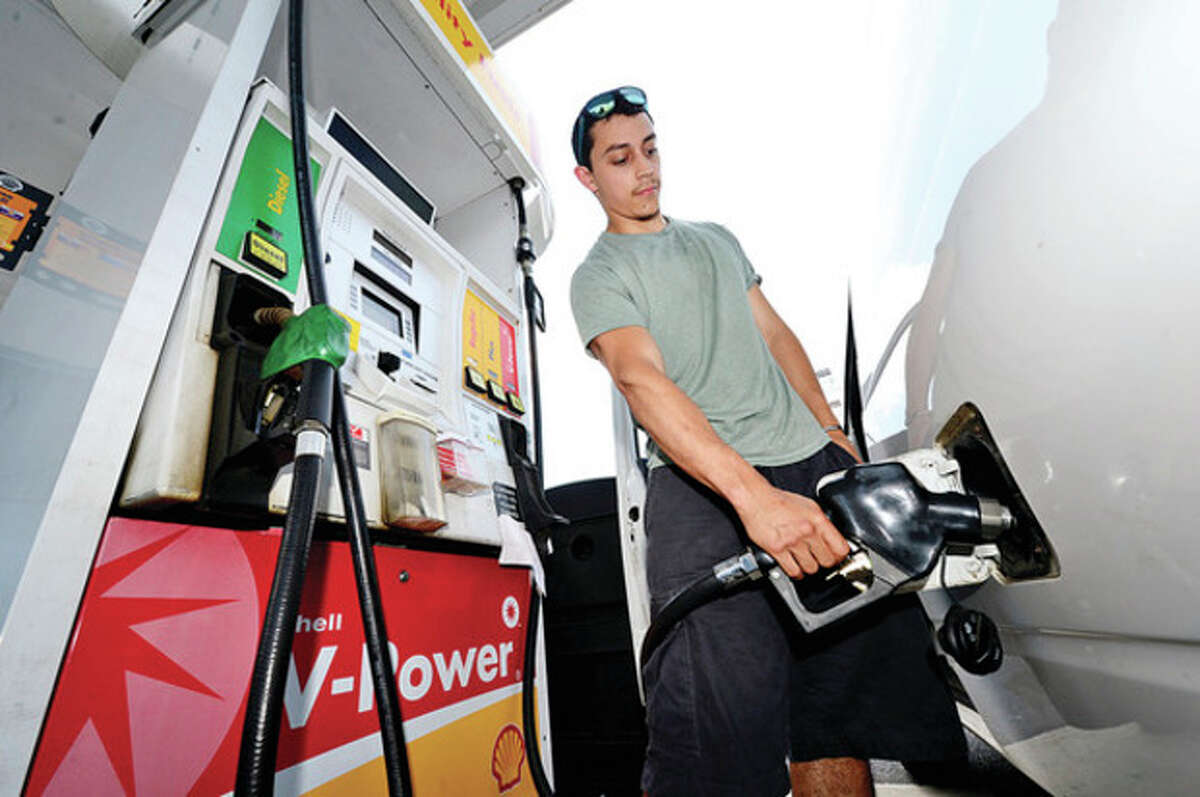 Baltazar Suarez fills up his work van for FRAMA Exclusives at a Shell Station on Main Ave. Friday. House Bill 6534 repeals a current requirement that Connecticut gas stations install and regularly maintain stage II vapor recovery systems on their gas pumps. Since 2000, on-board vapor recovery (ORVR) equipment has been incorporated directly into the design of all new passenger vehicles, which serves much the same purpose as state II vapor systems. The requirement was introduced in the early 1990's to prevent the emission of harmful ozone and other pollutants as customers refueled their cars. Hour photo / Erik Trautmann