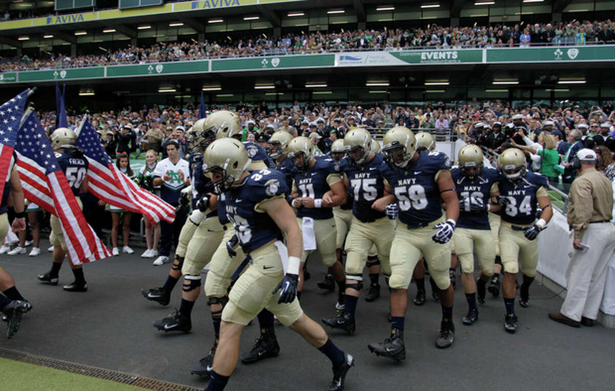 Navy football players make their way onto the pitch before their NCAA college football game against Notre Dame in Dublin, Ireland, Saturday, Sept. 1, 2012. (AP Photo/Peter Morrison)