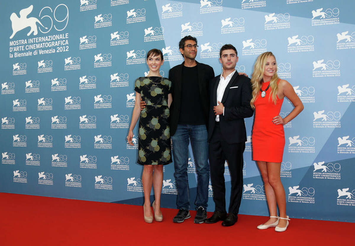 Screenwriter Hallie Elizabeth Newton, director Ramin Bahrani, actors Zac Efron and Maika Monroe pose at the photo call for the film 'At Any Price' during the 69th edition of the Venice Film Festival in Venice, Italy, Friday, Aug. 31, 2012. (AP Photo/Joel Ryan)