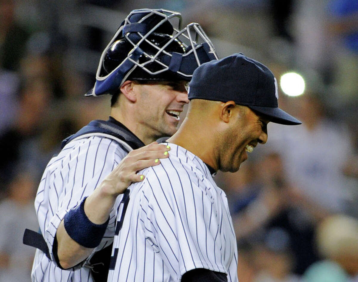 New York Yankees pitcher Mariano Rivera, right, celebrates with catcher Chris Stewart after they defeated the Boston Red Sox 4-1 in a baseball game on Friday, May 31, 2013, at Yankee Stadium in New York. (AP Photo/Bill Kostroun)