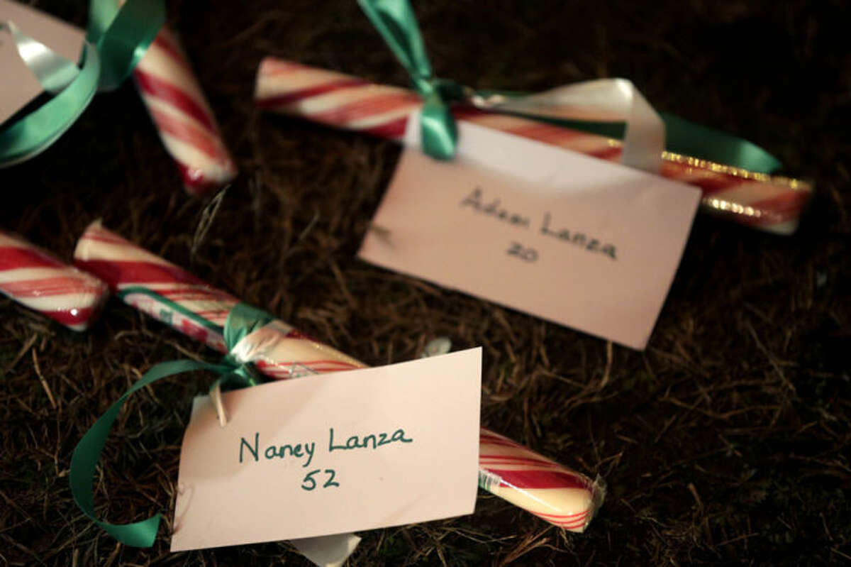 FILE - In this Thursday, Dec. 20, 2012 file photo, the names of Nancy Lanza and Adam Lanza are attached to candy at a memorial to the Newtown shooting victims in Newtown, Conn. A memorial service is planned in New Hampshire on Saturday, June 1, 2013, for Nancy Lanza, whose son Adam shot her to death in their Connecticut home in December before driving to Sandy Hook Elementary School and gunning down 20 students and six educators. (AP Photo/Seth Wenig, File)