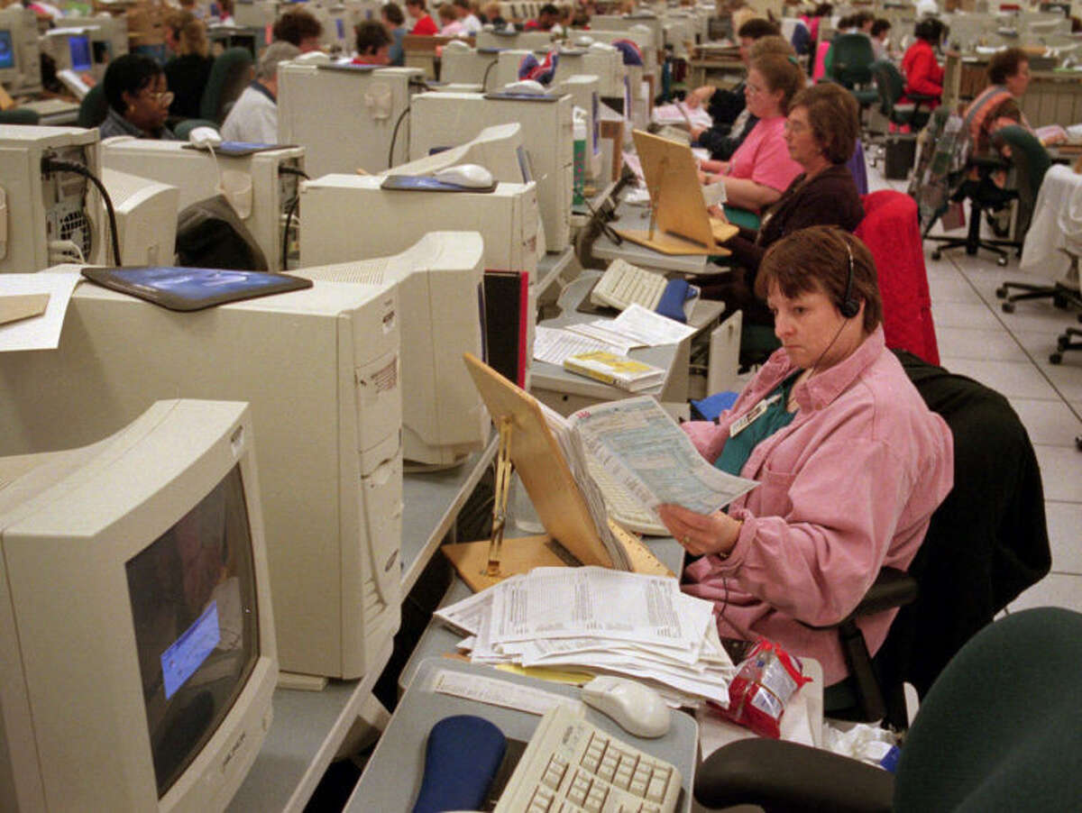 FILE - This April 29, 1999 file photo shows Internal Revenue Service (IRS) data transcribers put data from federal income tax returns into computers at the IRS Cincinnati Service Center in Covington, Ky. For a time, the Internal Revenue Service inspired awe and admiration in Americans, not just trepidation and lame jokes about death and taxes. Everyone loved the revenue agents when they put away the Chicago underworld?•s master of brutality and bribes, Al Capone, in a coup so spectacular it scared other gangsters straight. But that sentiment is of ages past. (AP Photo/David Kohl, File)