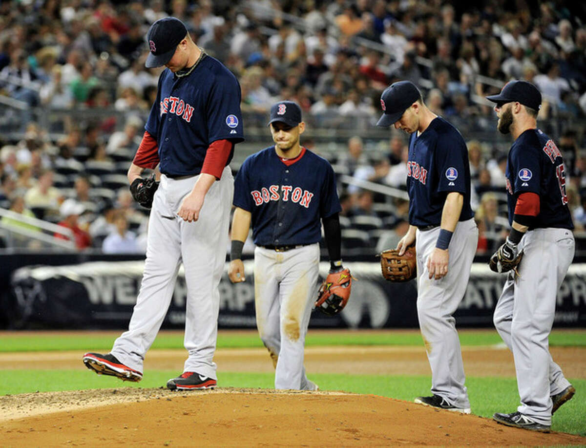 Boston Red Sox pitcher Jon Lester, left, reacts as his manager comes out to take him out during the seventh inning of a baseball game against the New York Yankees, Friday, May 31, 2013, at Yankee Stadium in New York. (AP Photo/Bill Kostroun)