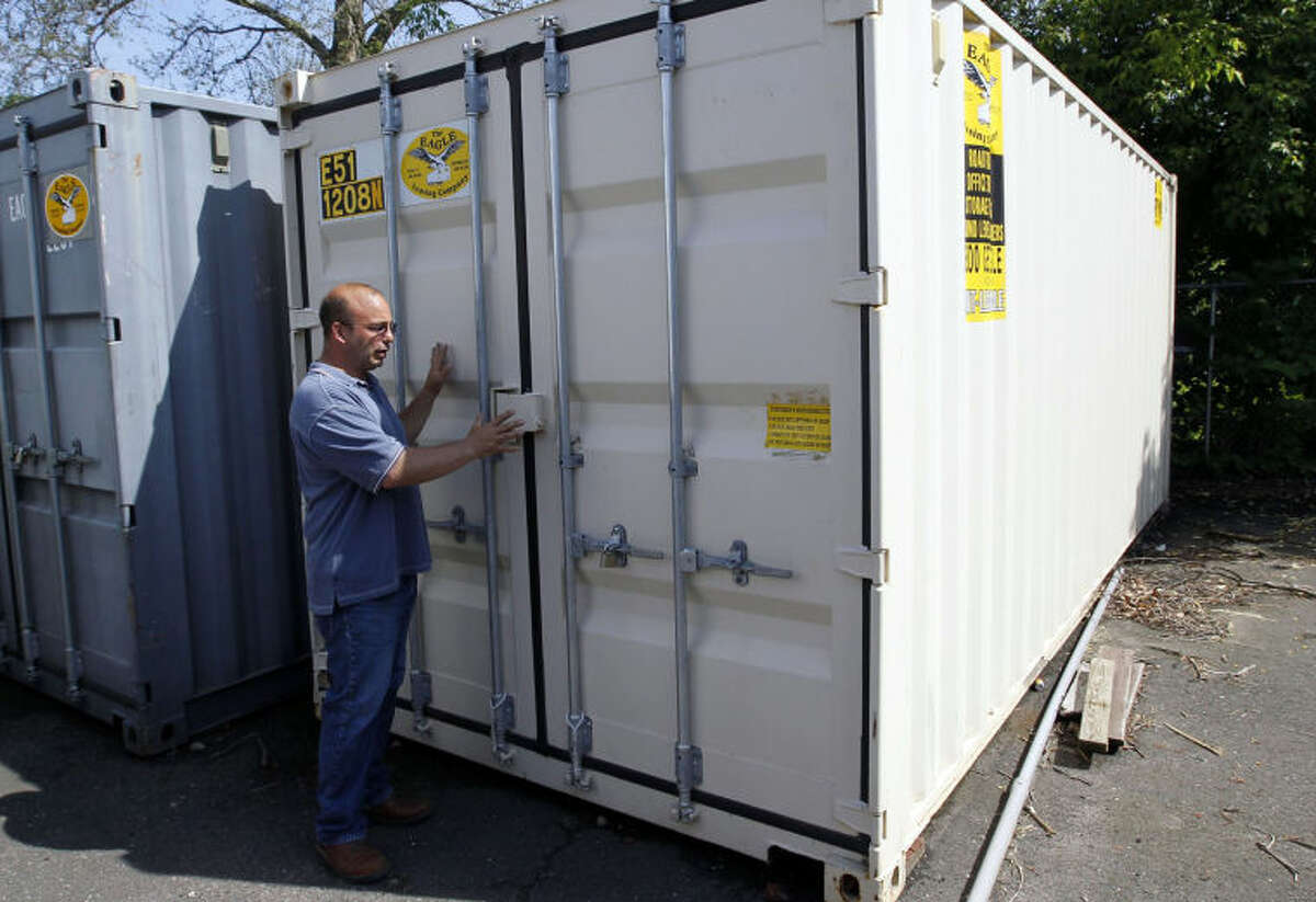 ADVANCE FOR WEEKEND EDITIONS JUNE 1-2 - In this May 20, 2013 photo, Joseph Palmieri, President of Connecticut Tank Removal Inc. and CEO of Palmieri Farm, opens a storage container, which he hopes will be transformed into a growing chamber for medical marijuana, in Bridgeport, Conn., Palmieri expects to house the container inside a building he purchased. (AP Photo/The Republican-American, Christopher Massa)