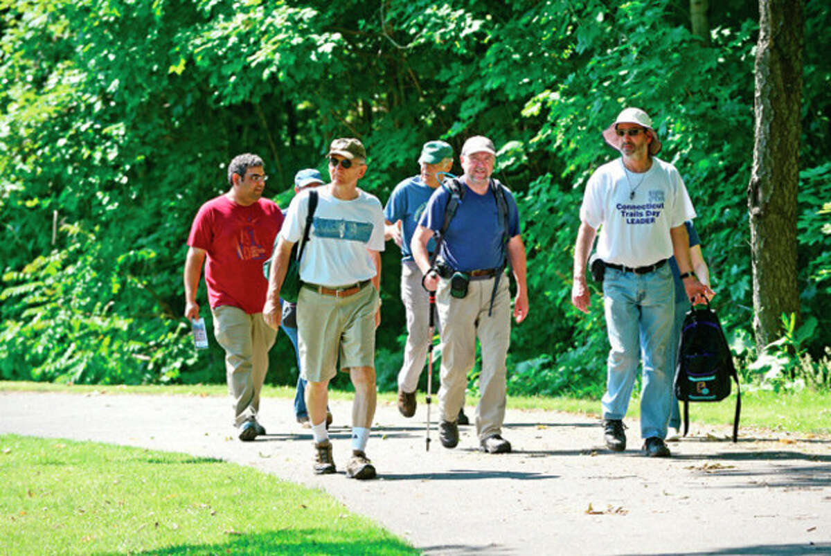 A group of hikers including Dennis D'Amato, Rob McWilliams and David Park start out on a moderate three-mile hike from Mathews Park on the Norwalf River Valley Trail to Deering Pond and as part of a slew of activities scheduled throughout the state in recognition of National Trails Day Weekend. Hour photo / Erik Trautmann