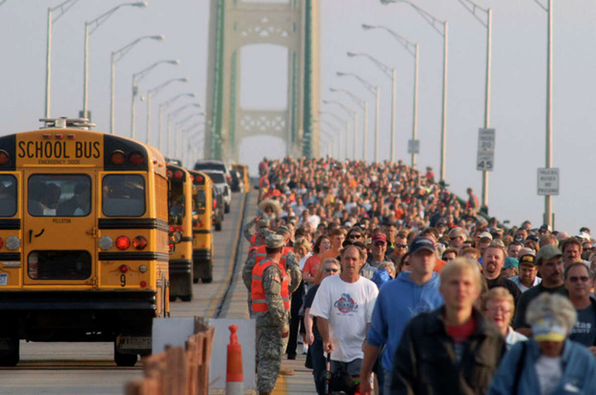 Thousands of people head south during the annual Labor Day Mackinac Bridge Walk, Monday, Sept. 3, 2012. Gov. Rick Snyder has led thousands of walkers and runners across the bridge for one of Michigan's most popular Labor Day traditions. (AP Photo/John L. Russell)