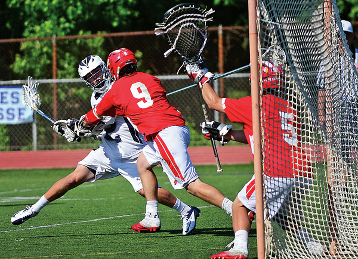Staples #22 Joey Zelkowitz takes a shot on goal during their lacrosse game against Greenwich Saturday. Hour photo / Erik Trautmann