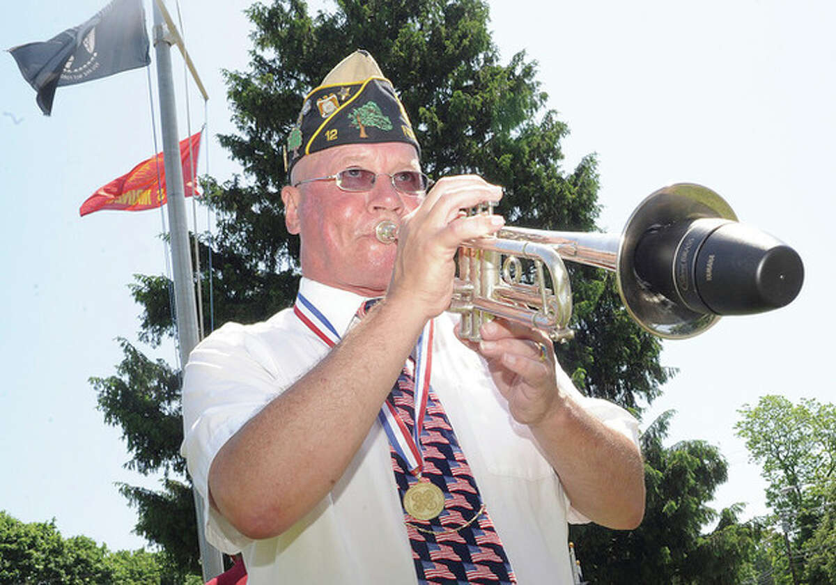Hour photo/Matthew Vinci Past Commander Buddy Scudder plays "To The Colors" Sunday at the Veteran of the Month ceremony in honor of Norwalk native and WW II vetertan William M. Flynn at the American Legion.