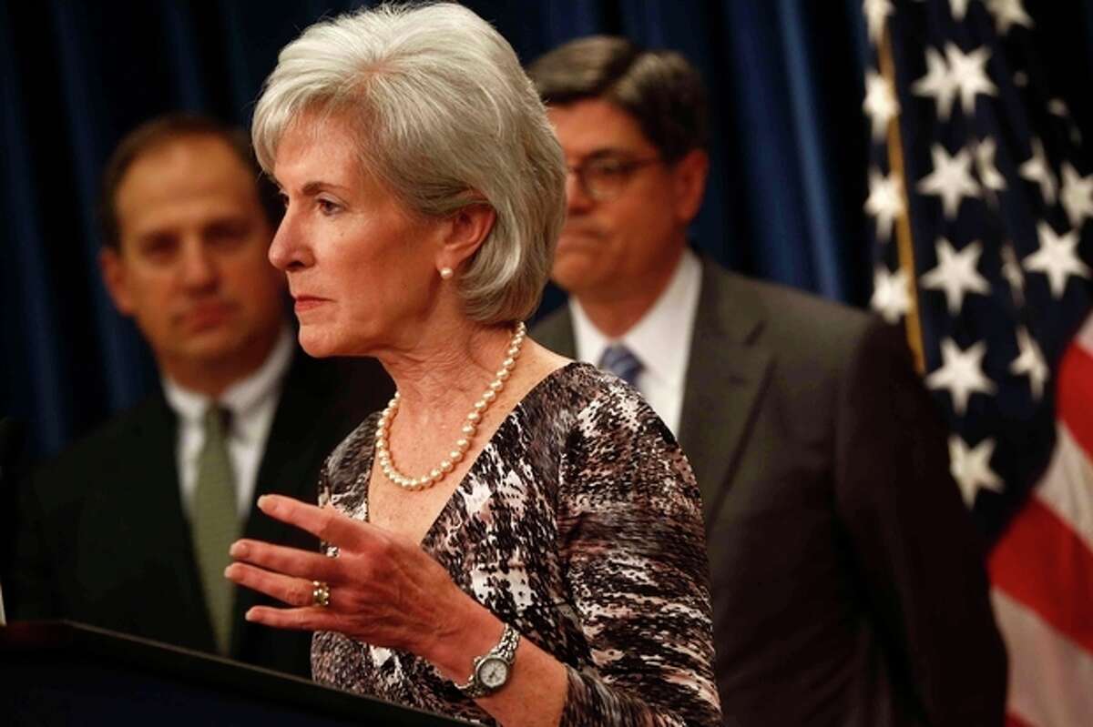 Health and Human Services Secretary Kathleen Sebelius, center, accompanied by Treasury Secretary Jacob Lew, right, and Acting Labor Secretary Seth D. Harris, speaks about Social Security and Medicare , Friday, May 31, 213, at the Treasury Department in Washington. The government says Medicare's giant hospital trust will not be exhausted until 2026, while the date that Social Security will exhaust its trust fund is unchanged at 2033. The date for Medicare is two years later than was projected last year. (AP Photo/Charles Dharapak)